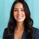 Portrait of Emily Rodriguez, a woman with long dark hair smiling.